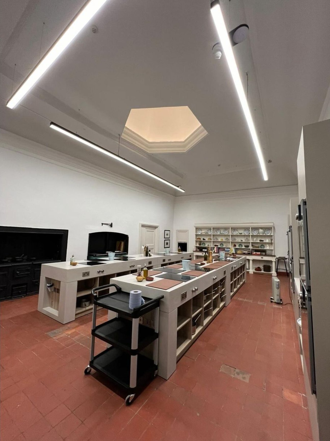 A teaching kitchen with long linear ceiling lights