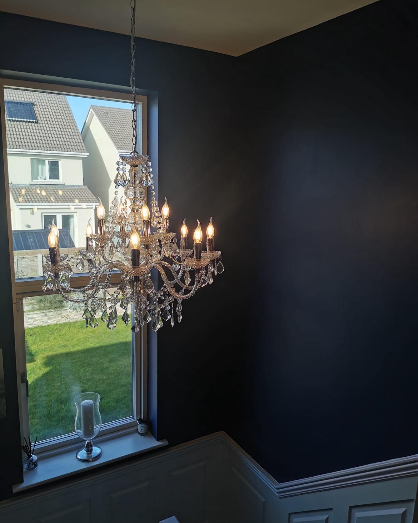 A crystal chandelier in a room with dark walls