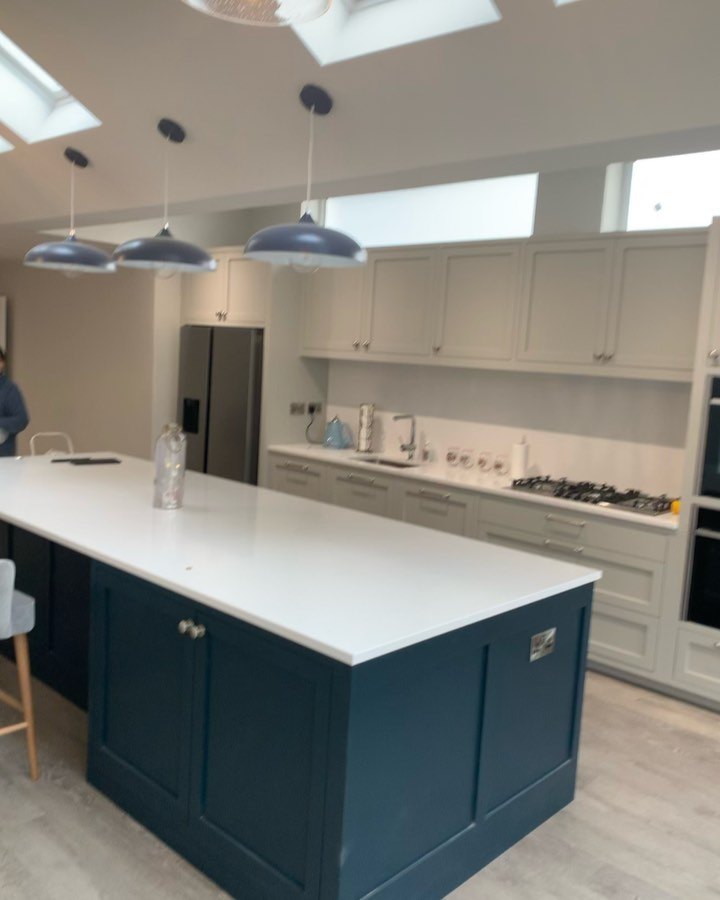A kitchen island under three pendant lights